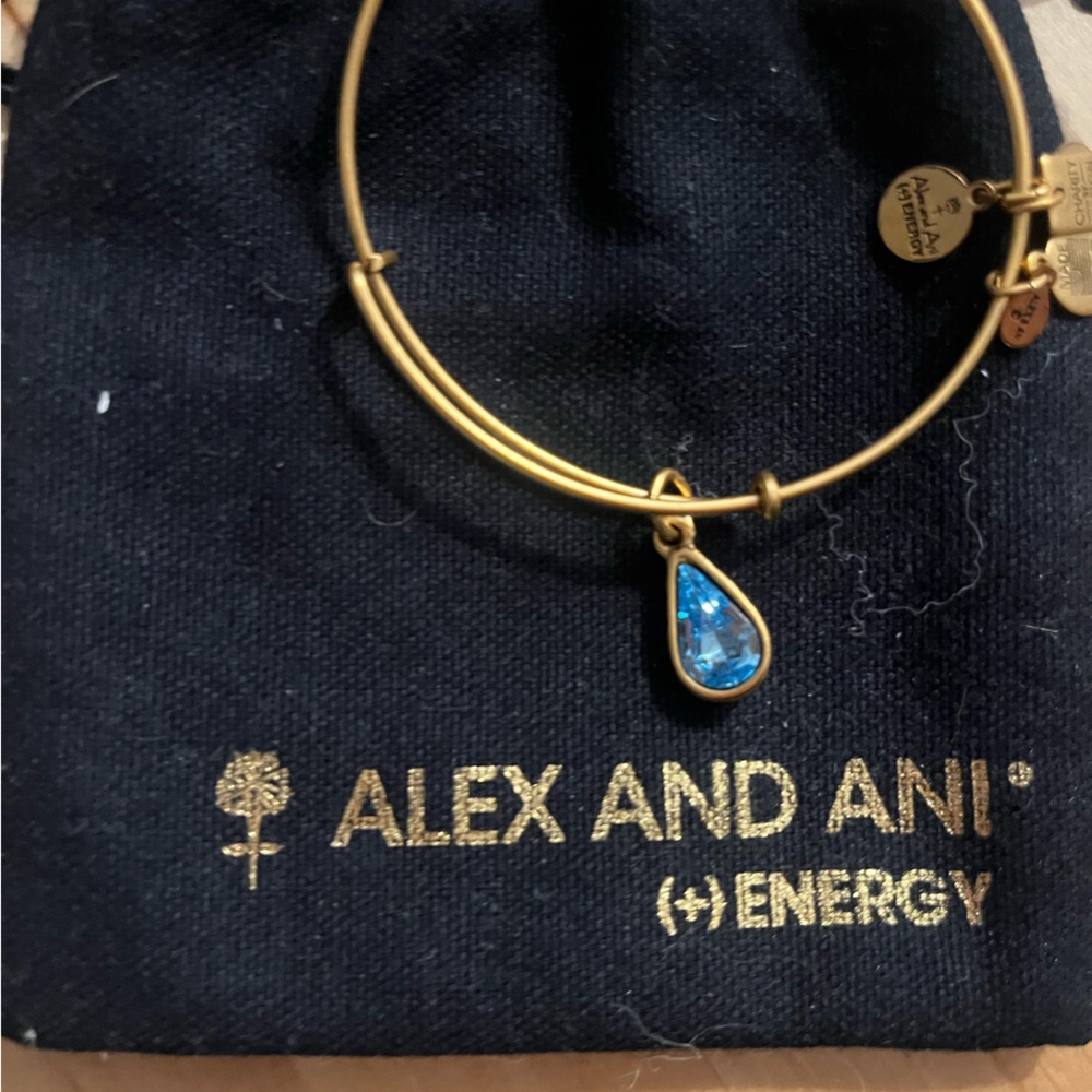 Alex and Ani bangle gold. Blue teardrop charm